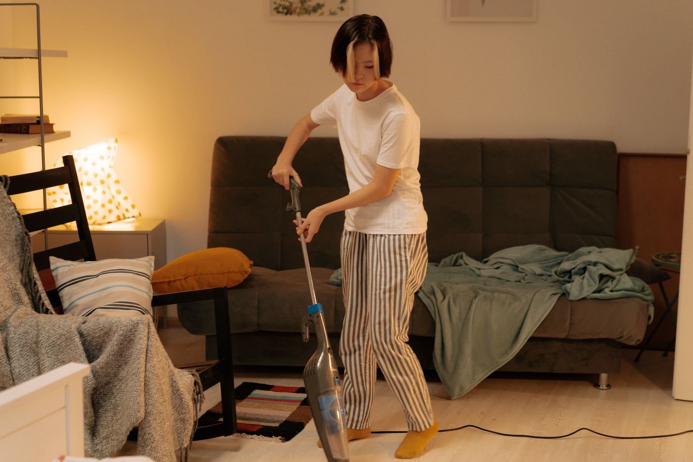 Cleaner vacuuming a tidy living room